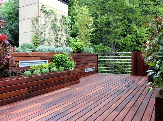 Diseño de terraza exterior en Madrid con jardineras de madera tropical